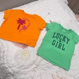 2 girls tshirts orange and green.